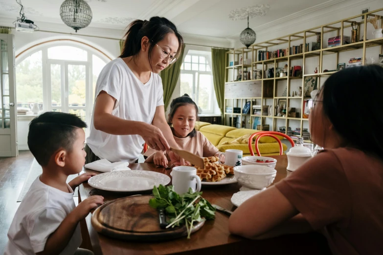 a woman serving food to a group of children, pexels contest winner, on kitchen table, chinese woman, husband wife and son, avatar image