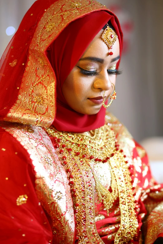 a woman is dressed in red and gold, hurufiyya, wedding photography, islamic, candid photograph, square