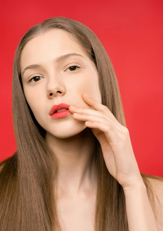 a beautiful young woman brushing her teeth against a red background, trending on pexels, fantastic realism, square jaw-line, 5 0 0 px models, portrait sophie mudd, hand on cheek