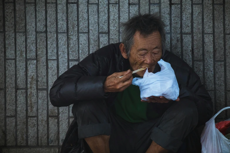 a man sitting on the ground eating food, inspired by Zhang Kechun, pexels contest winner, hyperrealism, cyberpunk old man, youtube thumbnail, devouring the human soul, people on the streets