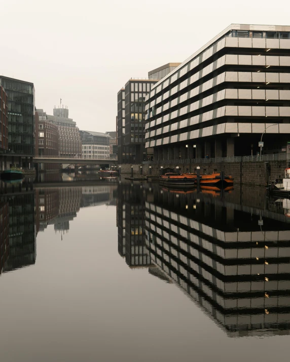 a white boat sitting on top of a body of water, a photo, inspired by David Chipperfield, pexels contest winner, brutalism, hannover, reflections on wet streets, grey skies with two rainbows, thumbnail