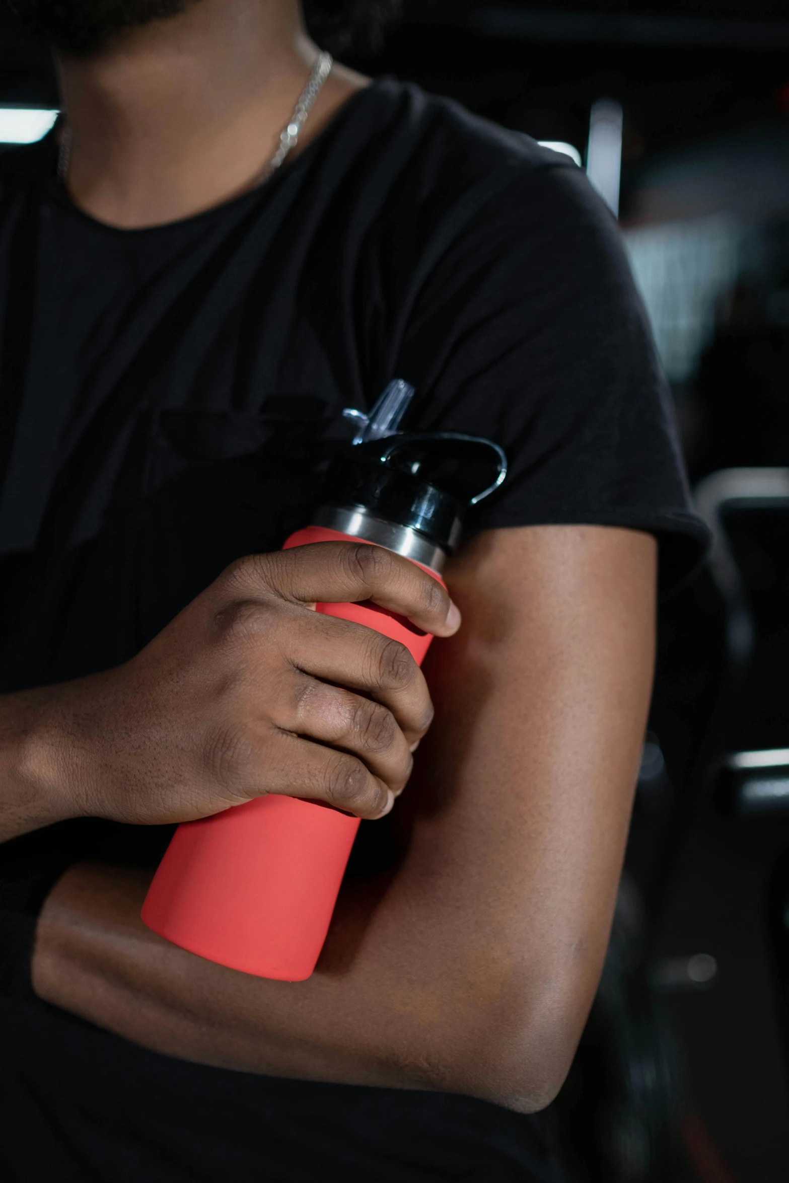 a close up of a person holding a water bottle, slightly red, matte finish, strong arms, detailed product image