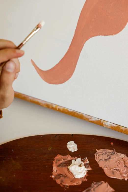 a close up of a person painting on a canvas, inspired by Francesco Clemente, trending on pexels, arbeitsrat für kunst, brown and pink color scheme, simple curvilinear watercolor, flowing salmon-colored silk, studio shot