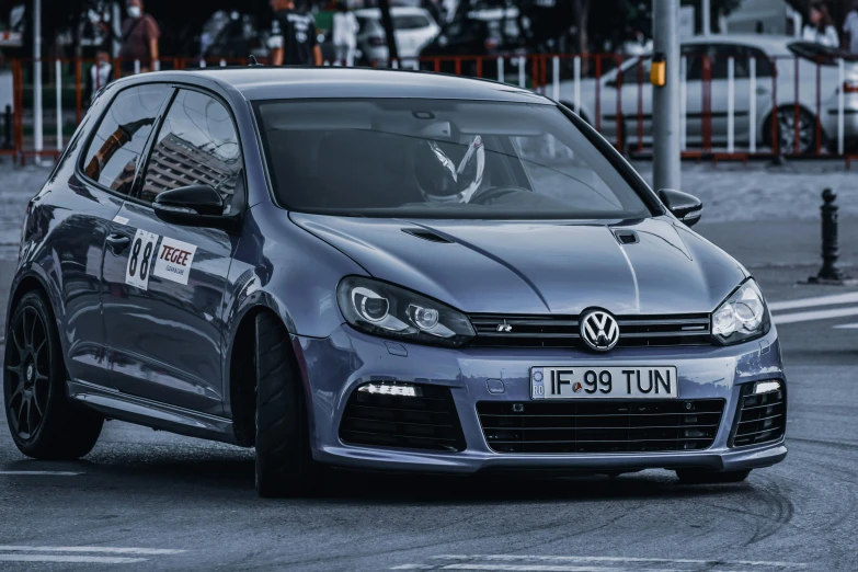 a close up of a car on a city street, by Adam Marczyński, pexels contest winner, in a race competition, touareg, horns, modified