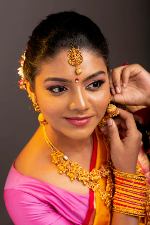 a woman putting a necklace on another woman's neck, trending on cg society, hurufiyya, pink and gold color scheme, portrait photo, hindu, square