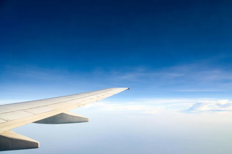 the wing of an airplane flying in the sky, by Peter Churcher, minimalism, fan favorite, rectangular, lightweight, sky blue