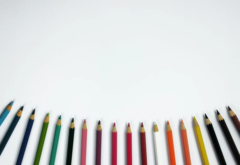 a row of colored pencils sitting next to each other, a minimalist painting, by Carey Morris, pexels, minimalism, white backdrop, !pencil, multiple stories, miscellaneous objects