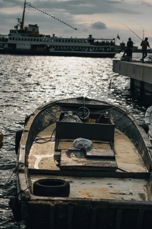 a boat that is sitting in the water, by Elsa Bleda, happening, docked at harbor, close-up photograph, grey, 2022 photograph