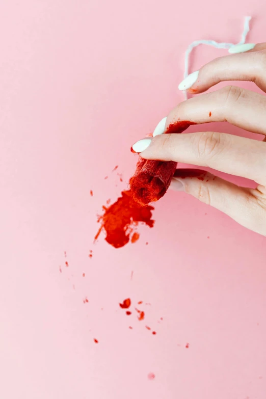 a close up of a person holding a piece of food, inspired by Elsa Bleda, bloody scene, candy treatments, raspberry, profile image