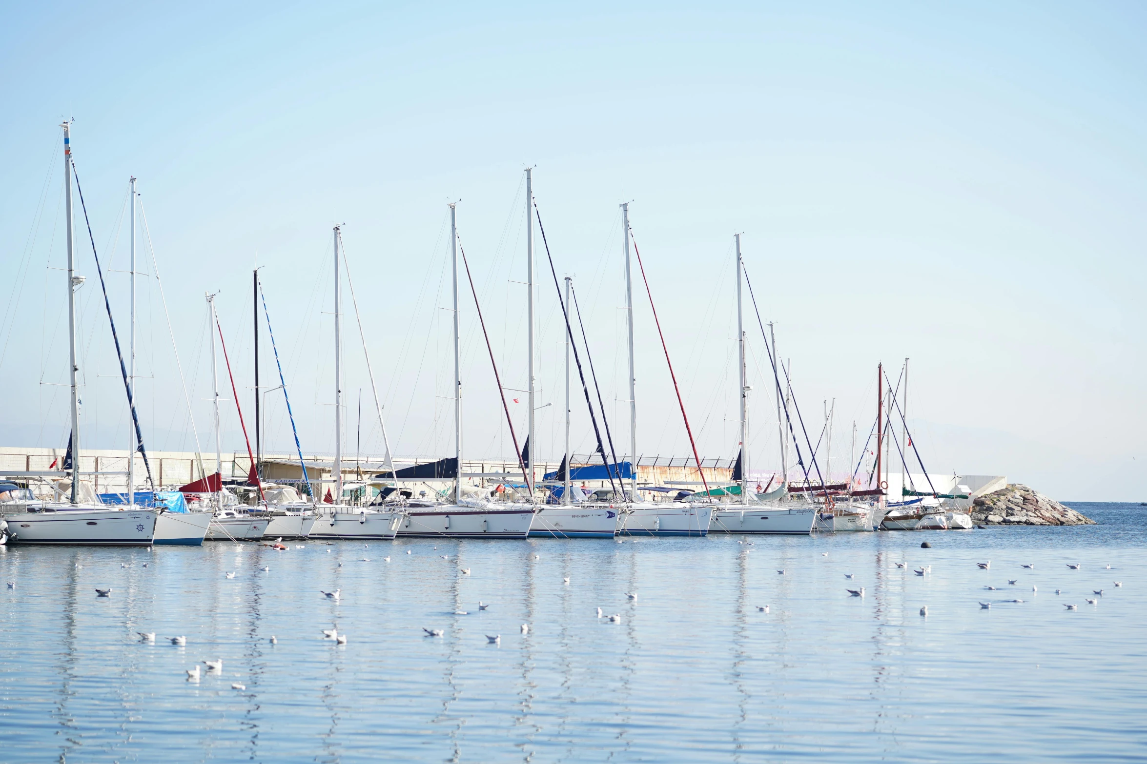 a number of boats in a body of water, pexels contest winner, les nabis, white cyc, slightly sunny, split near the left, moored
