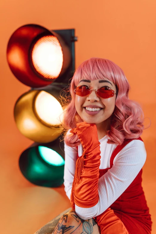 a woman with pink hair sitting in front of a traffic light, inspired by Natasha Tan, orange and red lighting, pokimane, playful and cheerful, red contacts