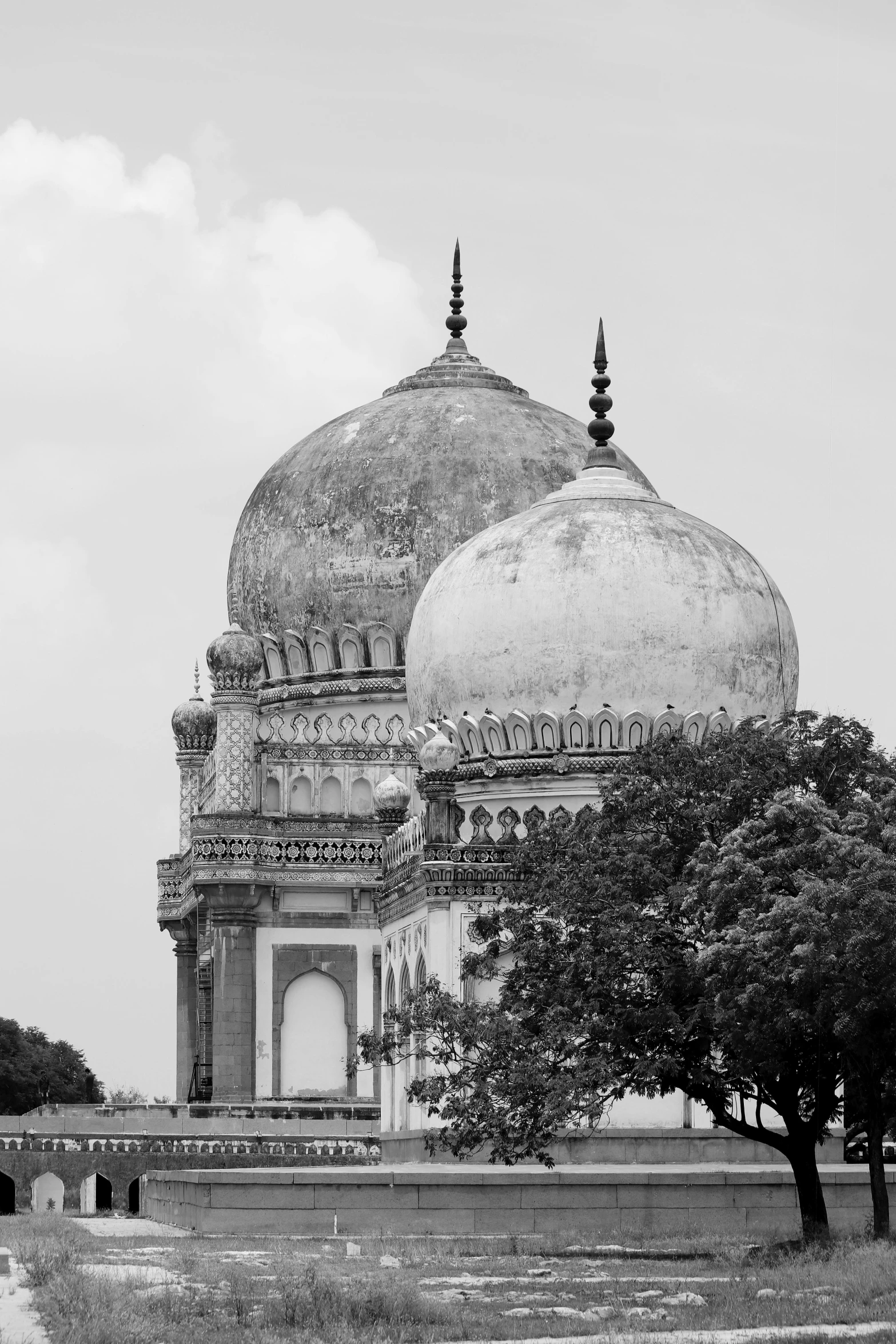 a black and white photo of a large building, a black and white photo, by Bholekar Srihari, trending on unsplash, arabesque, mausoleum, domes, idyllic, dome