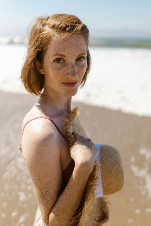 a woman standing on a beach holding a teddy bear, a portrait, by Matthias Stom, unsplash, renaissance, ginger hair with freckles, on a sunny beach, slide show, decolletage