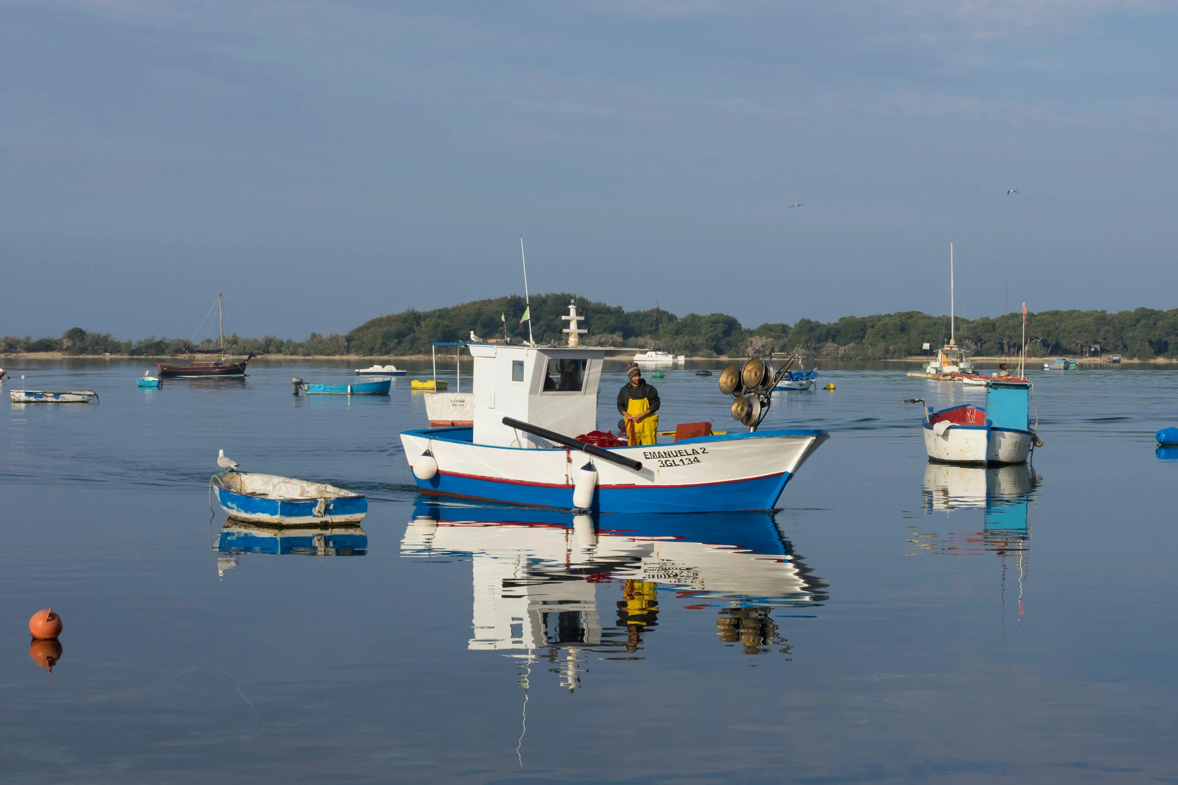 a group of boats floating on top of a body of water, a picture, inspired by Charles Cundall, pexels contest winner, reflective chitin, fisherman, aruba, late summer evening