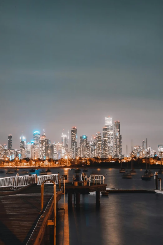 a large body of water with a city in the background, by Ryan Pancoast, pexels contest winner, caulfield, high lights, background image, stacked image