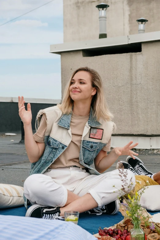a couple of women sitting on top of a blue blanket, inspired by Louisa Matthíasdóttir, trending on unsplash, graffiti, outfit : jeans and white vest, sydney sweeney, sits on a rooftop, on a spaceship