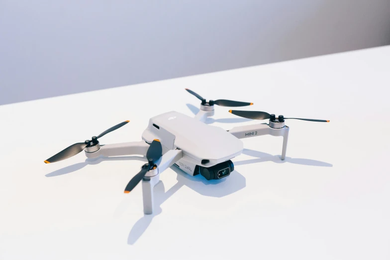 a small white drone sitting on top of a table, a 3D render, by Carey Morris, unsplash, bauhaus, handheld, 2024, fan favorite, alexa mini