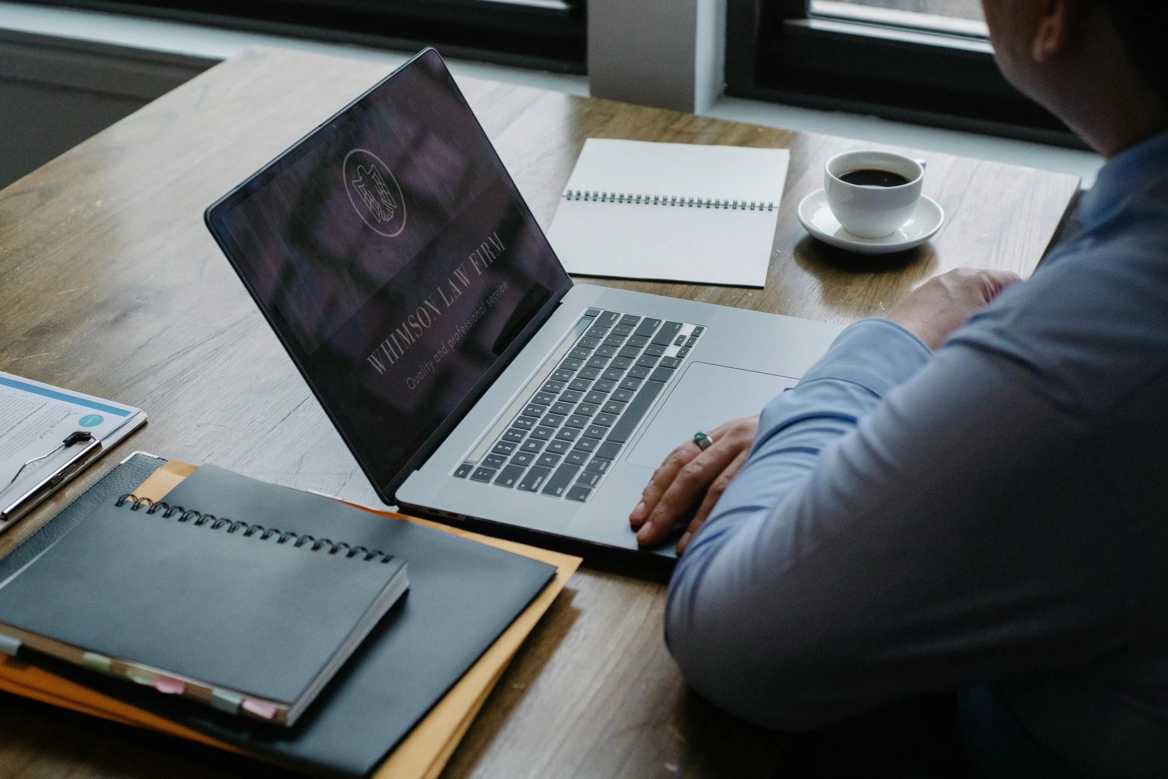 a man sitting at a table working on a laptop, a computer rendering, by Carey Morris, trending on unsplash, renaissance, lawyer clothing, professional logo design, cover shot, j. h. williams iii