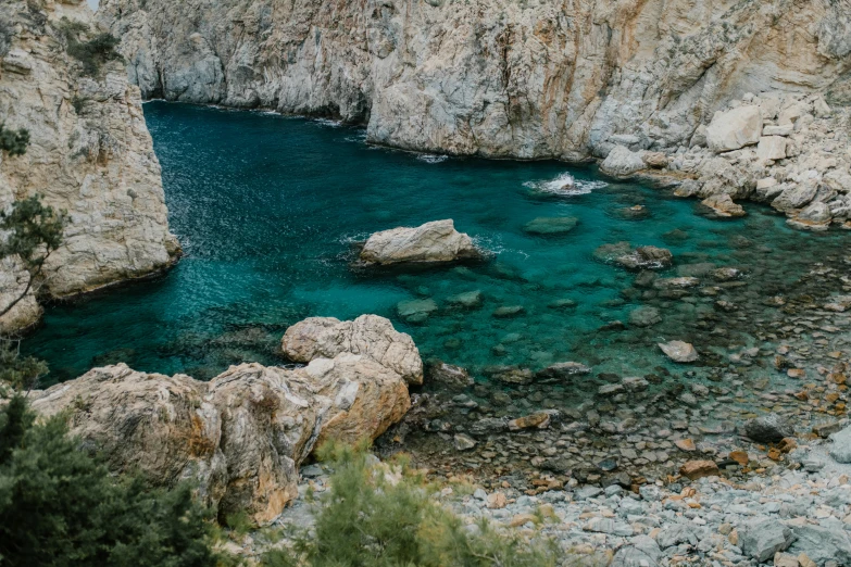 a body of water surrounded by rocks and trees, pexels contest winner, les nabis, glass antikythera, sea - green and white clothes, cyan and gold scheme, thumbnail