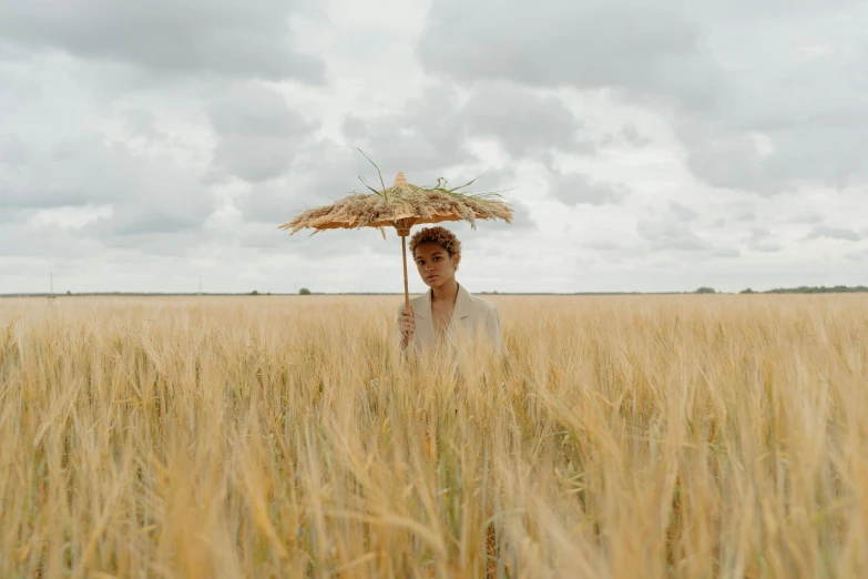 a person standing in a field holding an umbrella, ashteroth, straw hat, avatar image, ignant