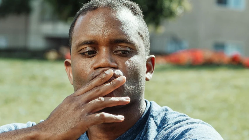 a man smokes a cigarette in a park, by Paul Davis, pexels contest winner, jordan peele's face, hand on cheek, swollen muscles, “hyper realistic