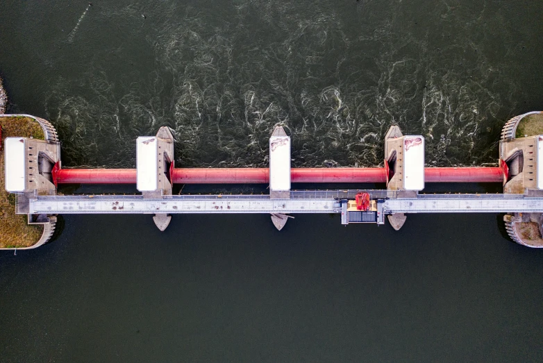 an overhead view of a bridge over a body of water, by Jan Rustem, happening, thrusters, maintenance photo, red river, in a row