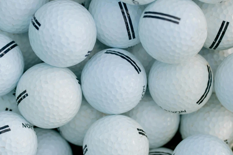 a pile of white golf balls with black stripes, unsplash, photorealism, colour photo, conor walton, face shot, thumbnail