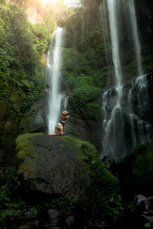 a man standing in front of a waterfall, inspired by Steve McCurry, sumatraism, **cinematic, bali, panoramic view of girl, paul barson
