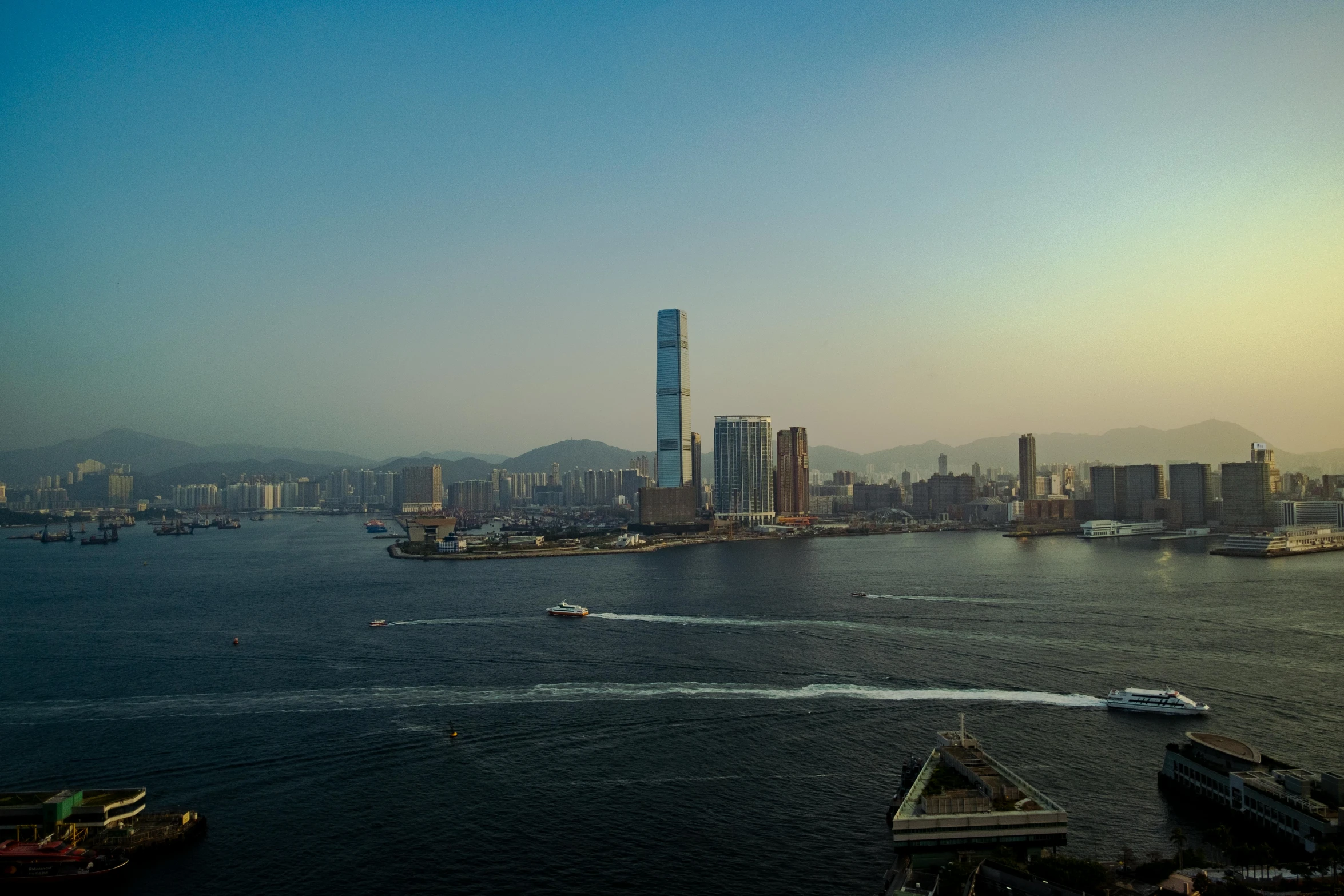 a large body of water with a city in the background, pexels contest winner, hyperrealism, kowloon, slide show, beeple colors, cinematic morning light