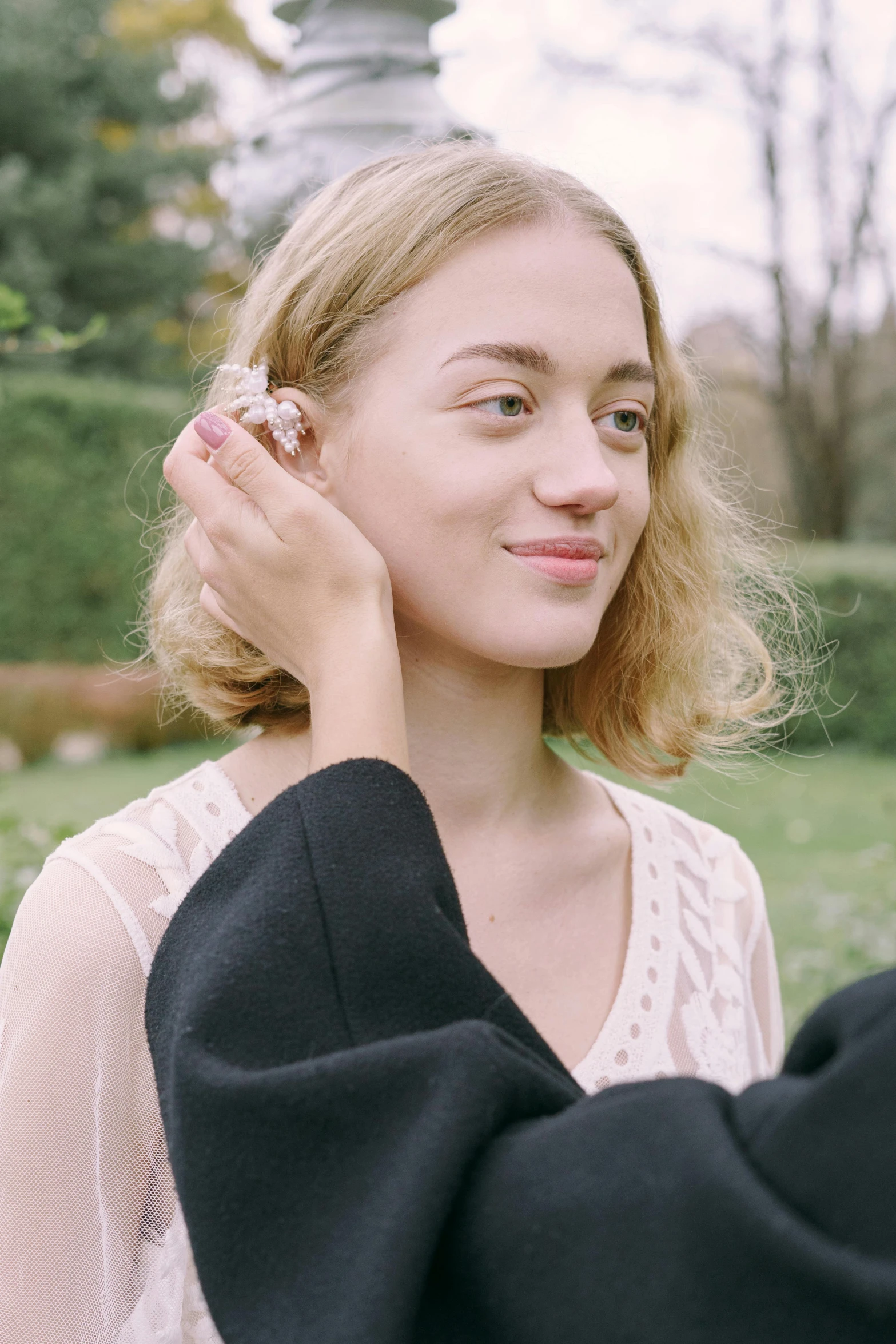 a man putting a ring on a woman's ear, an album cover, inspired by Marc-Aurèle de Foy Suzor-Coté, trending on pexels, julia garner, in the garden, soft portrait shot 8 k, transparent