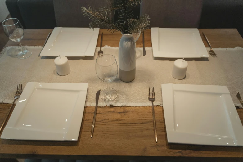 a wooden table topped with white plates and silverware, inspired by Constantin Hansen, unsplash, renaissance, low quality photo, square, decoration, 5k