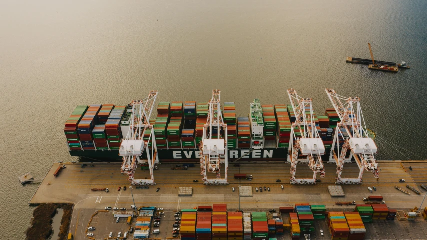 a large container ship sitting on top of a body of water, cranes, flatlay, a green, avatar image