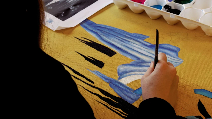 a person is painting a picture on a table, inspired by Qi Baishi, arbeitsrat für kunst, velvet art, banner, lightblue acrylic paintdrip tar, ink and muted colours on silk