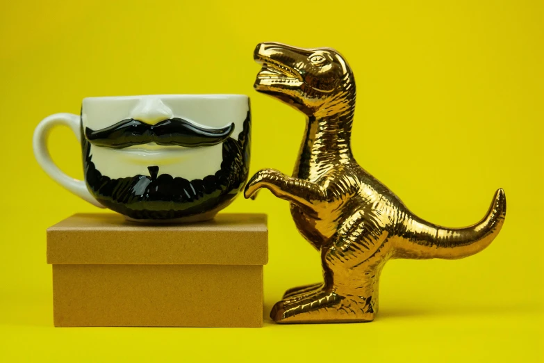 a gold dinosaur figurine next to a coffee cup, pop art, bushy moustache, made of smooth black goo, a handsome, ceramic