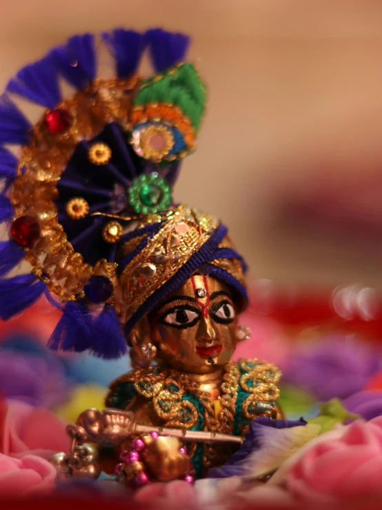 a figurine sitting on top of a bed of flowers, by Sudip Roy, pexels contest winner, samikshavad, wearing a bejeweled mask, god\'s creation, dancer, innocent look. rich vivid colors