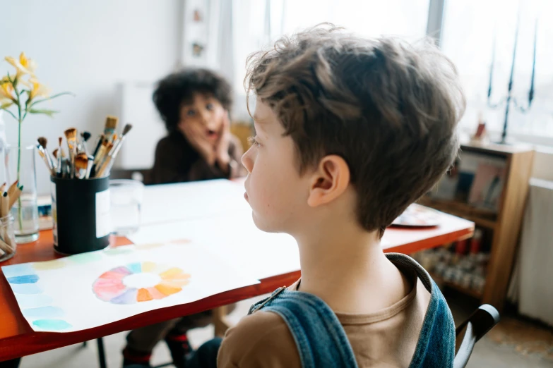 a little boy that is sitting at a table, pexels contest winner, visual art, looking at each other mindlessly, school curriculum expert, person in foreground, on a canva