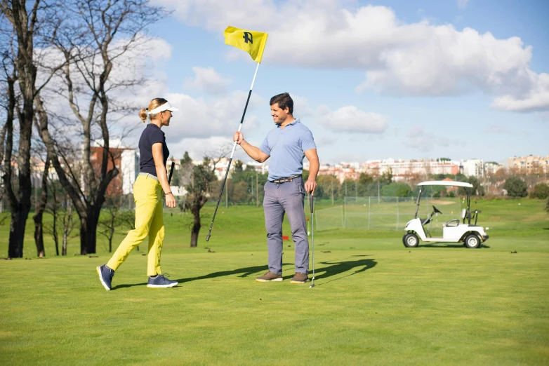 a couple of men standing on top of a green field, camilo gc, green flag, monika, practice