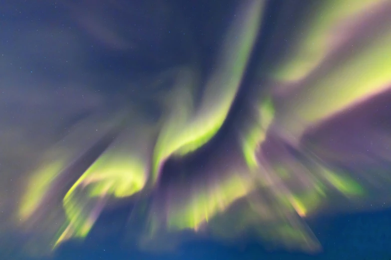 the aurora lights in the sky above a body of water, by Terese Nielsen, pexels contest winner, hurufiyya, spiral clouds, purple and green, abstract lighting, glowing drapes