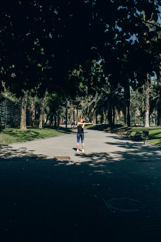 a person riding a skateboard down a street, unsplash, standing in a botanical garden, panoramic centered view of girl, running in savannah, in spain