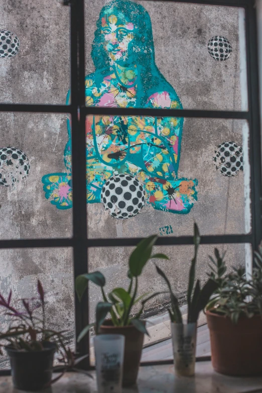 a cat sitting on a window sill next to potted plants, a silk screen, by Daarken, trending on unsplash, street art, colorful glass wall, with kerala motifs, high view, wall mural