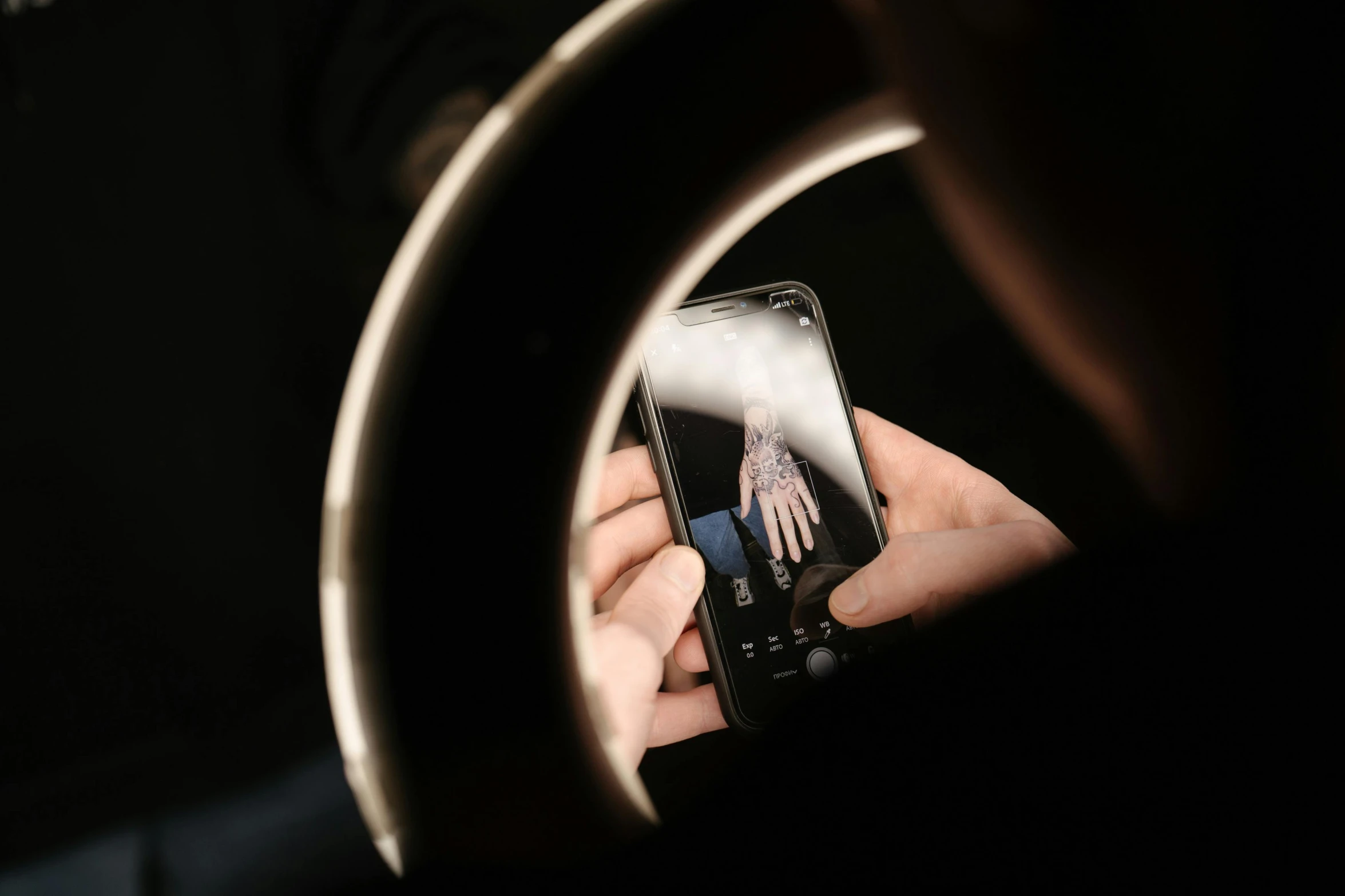 a close up of a person holding a cell phone, a hologram, by Matthias Stom, trending on pexels, photorealism, lighting her with a rim light, product photo studio lighting, behind the scenes, medium format. soft light