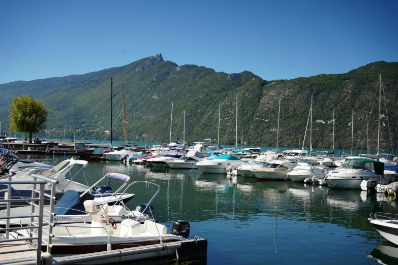 a number of boats in a body of water, by Bernard D’Andrea, pexels contest winner, alpes, sunny day time, carrington, port
