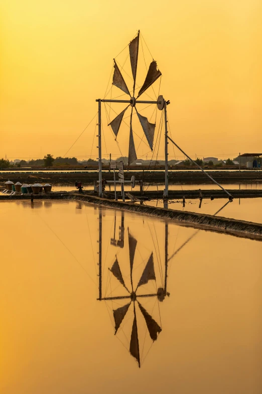 a windmill sitting on top of a body of water, rice paddies, refracted sunset lighting, best photo, full frame image