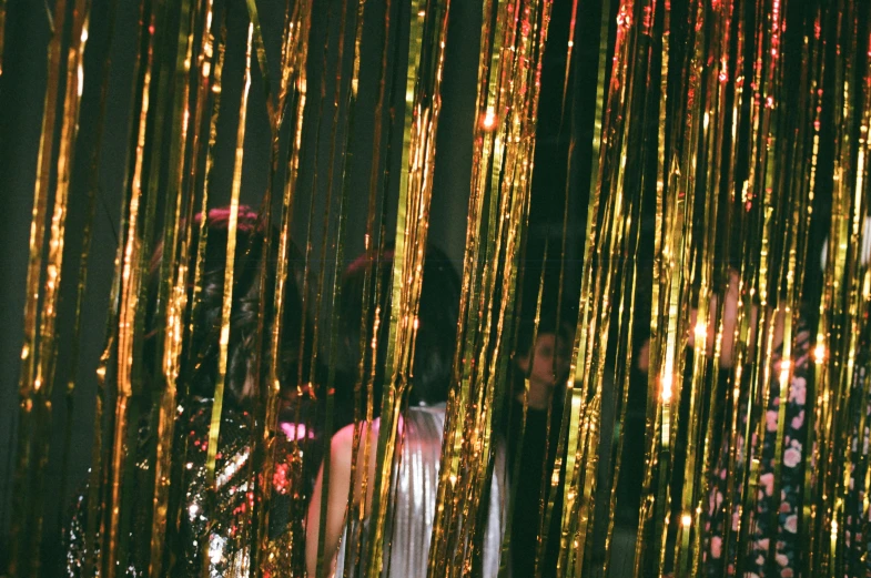 a group of people standing in front of a curtain, an album cover, by Elsa Bleda, pexels, art nouveau, glitter gif, dancefloor, gold wires, streamers