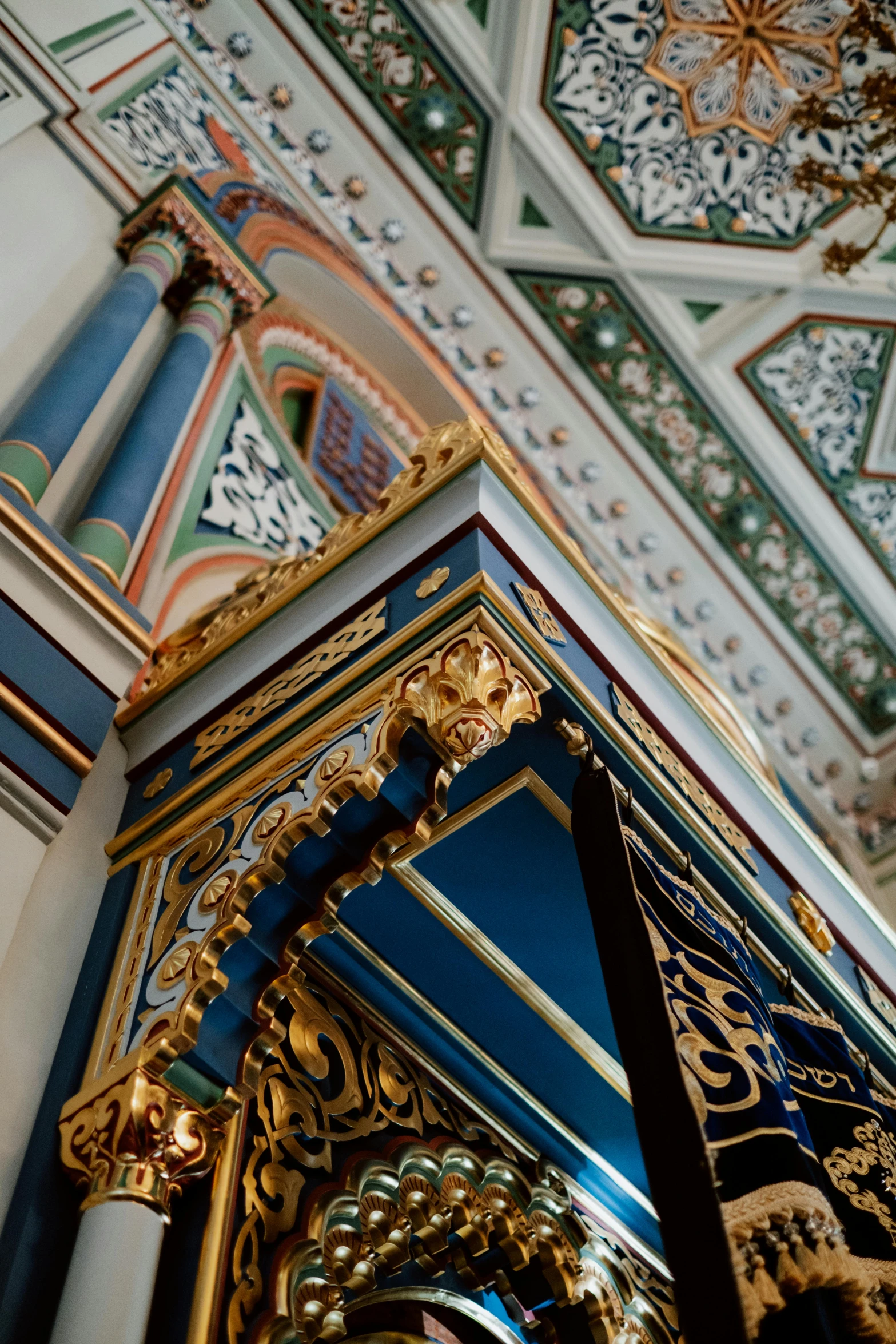 a clock hanging from the ceiling of a building, russian temple, blue and gold palette, inside the sepulchre, scrollwork