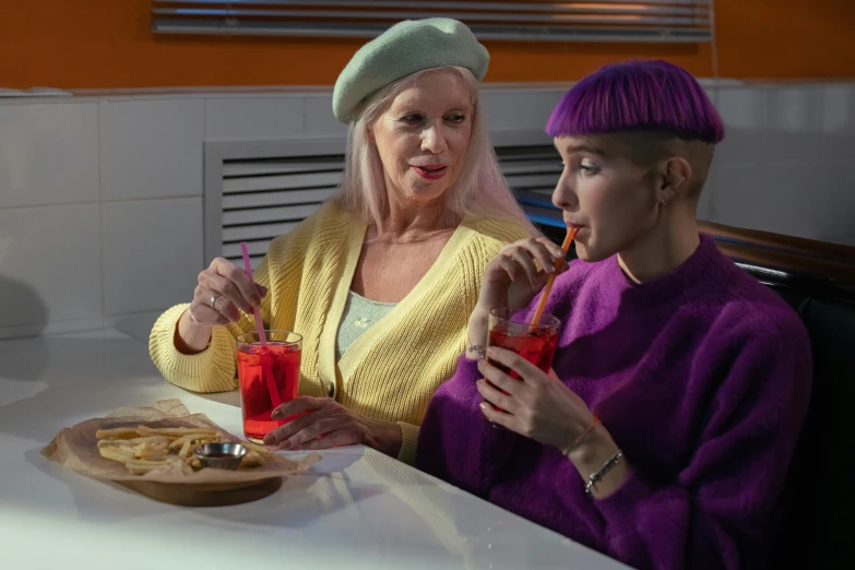 a couple of women sitting next to each other at a table, trending on pexels, fantastic realism, die antwoord style wear, cold drinks, purple clothes, older woman
