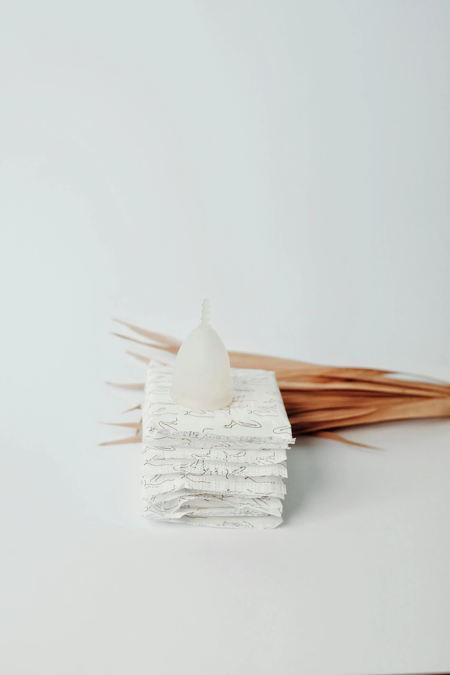 a bunch of toothpicks sitting on top of a pile of paper, a marble sculpture, unsplash, candle dripping white wax, white powder bricks, made of lab tissue, with a white background