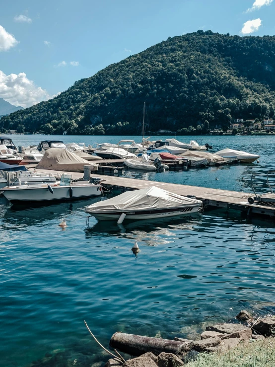 a number of boats in a body of water, by Julia Pishtar, pexels contest winner, renaissance, lakeside mountains, slim aarons, high quality print, sunny day time