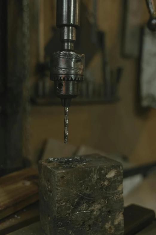 a drill sitting on top of a piece of metal, inspired by Jacob Maris, renaissance, medium level shot, stone table, still frame, high production value
