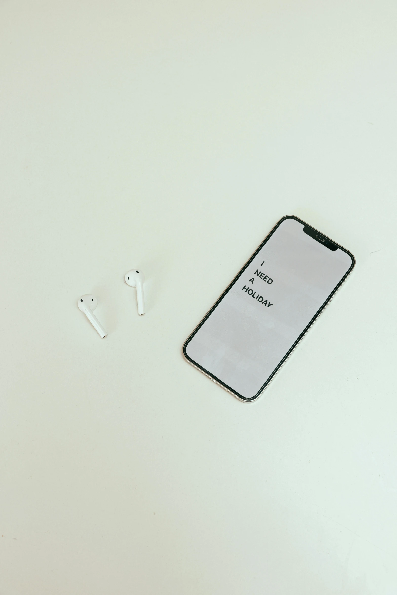 a cell phone sitting on top of a white table, pexels, airpods, 256x256, with japanese text, no background